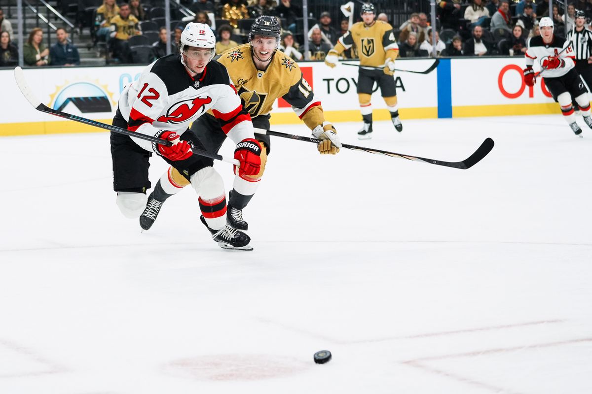 Devils center Cody Glass (12) and Golden Knights right wing Pavel Dorofeyev (16) race towards the puck during third period of NHL game against New Jersey Devils on Wed., Dec. 17, 2025, at T-Mobile Arena in Las Vegas.