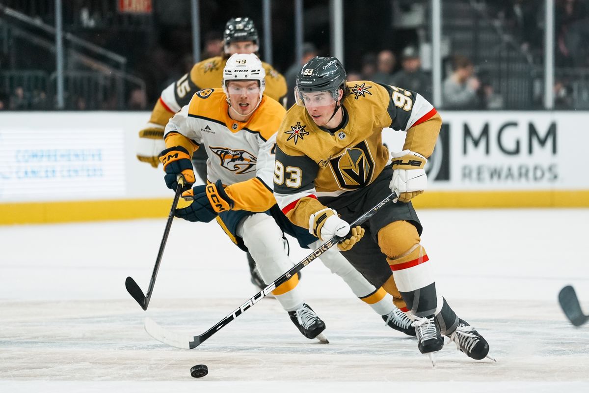 Vegas Golden Knights right wing Mitch Marner (93) tries to escape left wing Reid Schaefer (49) while skating the puck down the ice during first period of NHL game against Nashville Predators on Wed. Dec. 31, 2025 at T-Mobile Arena in Las Vegas.
