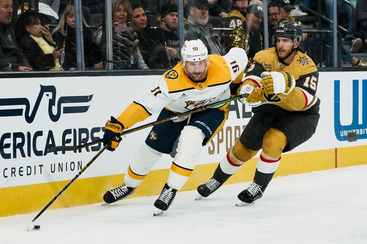 Nashville Predators center Steven Stamkos (91) and Knights defensemen Noah Hanifin (15) take the puck around the goal  during third period of NHL game against Vegas Golden Knights on Wed. Dec. 31, 2025 at T-Mobile Arena in Las Vegas.