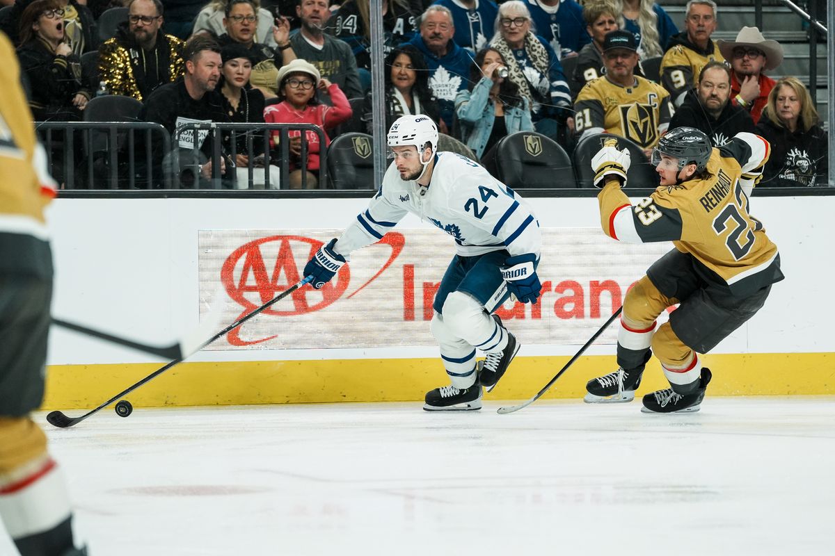 Toronto Maple Leafs center Scott Laughton (24) tries to escape Golden Knights left wing Cole Reinhardt during NHL game against Vegas Golden Knights on Thursday Jan. 15, 2026 at T-Mobile Arena in Las Vegas.
