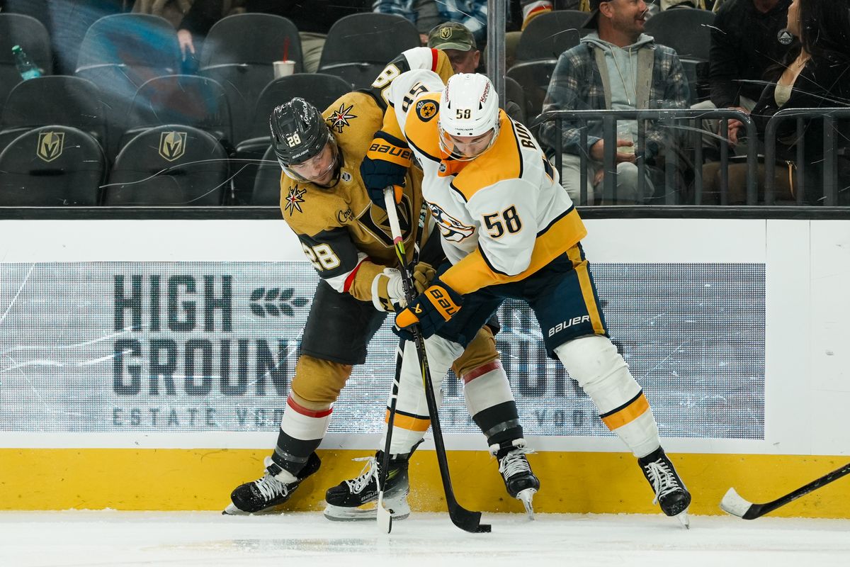 Vegas Golden Knights center Tanner Laczynski (28) and Nashville Predators left wing Michael Bunting (58) battle for the puck during third period of NHL game against Nashville Predators on Saturday Jan. 17, 2026 at T-Mobile Arena in Las Vegas.