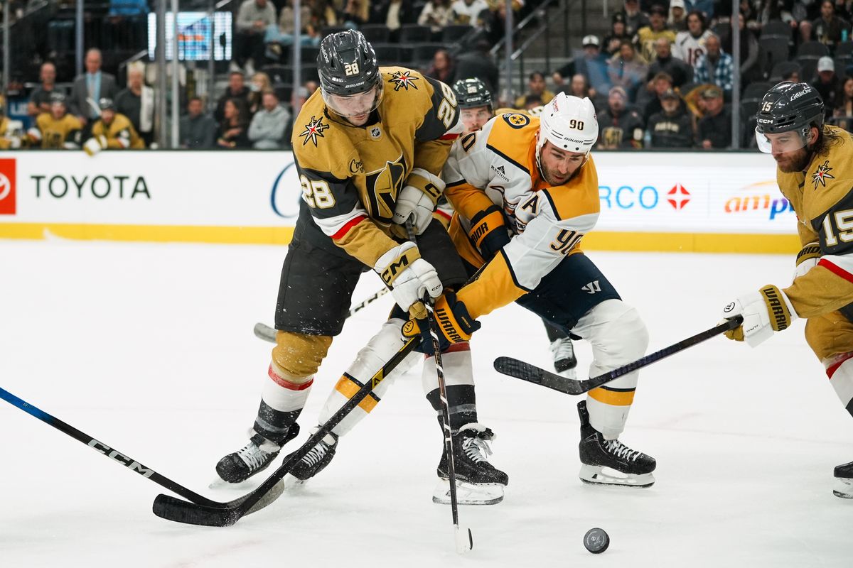 Vegas Golden Knights center Tanner Laczynski (28) and Nashville Predators center Ryan O’Reilly (90) battle for the puck during third period of NHL game against Nashville Predators on Saturday Jan. 17, 2026 at T-Mobile Arena in Las Vegas.