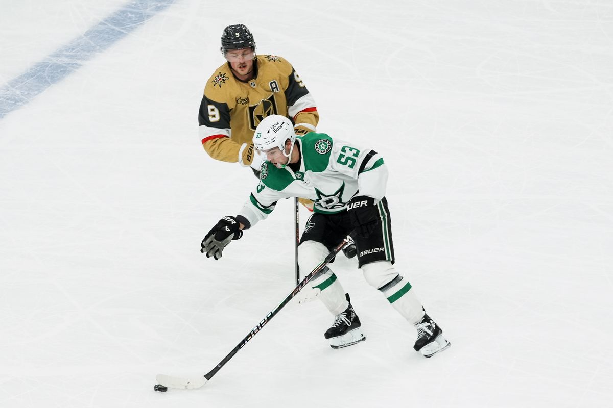 Dallas Stars right center Wyatt Johnston (53) skates the puck down the ice while  Golden Knights center Jack Eichel (9) skates behind him during second period of NHL game against Vegas Golden Knights on Thursday Jan. 29, 2026 at T-Mobile Arena in Las Vegas.