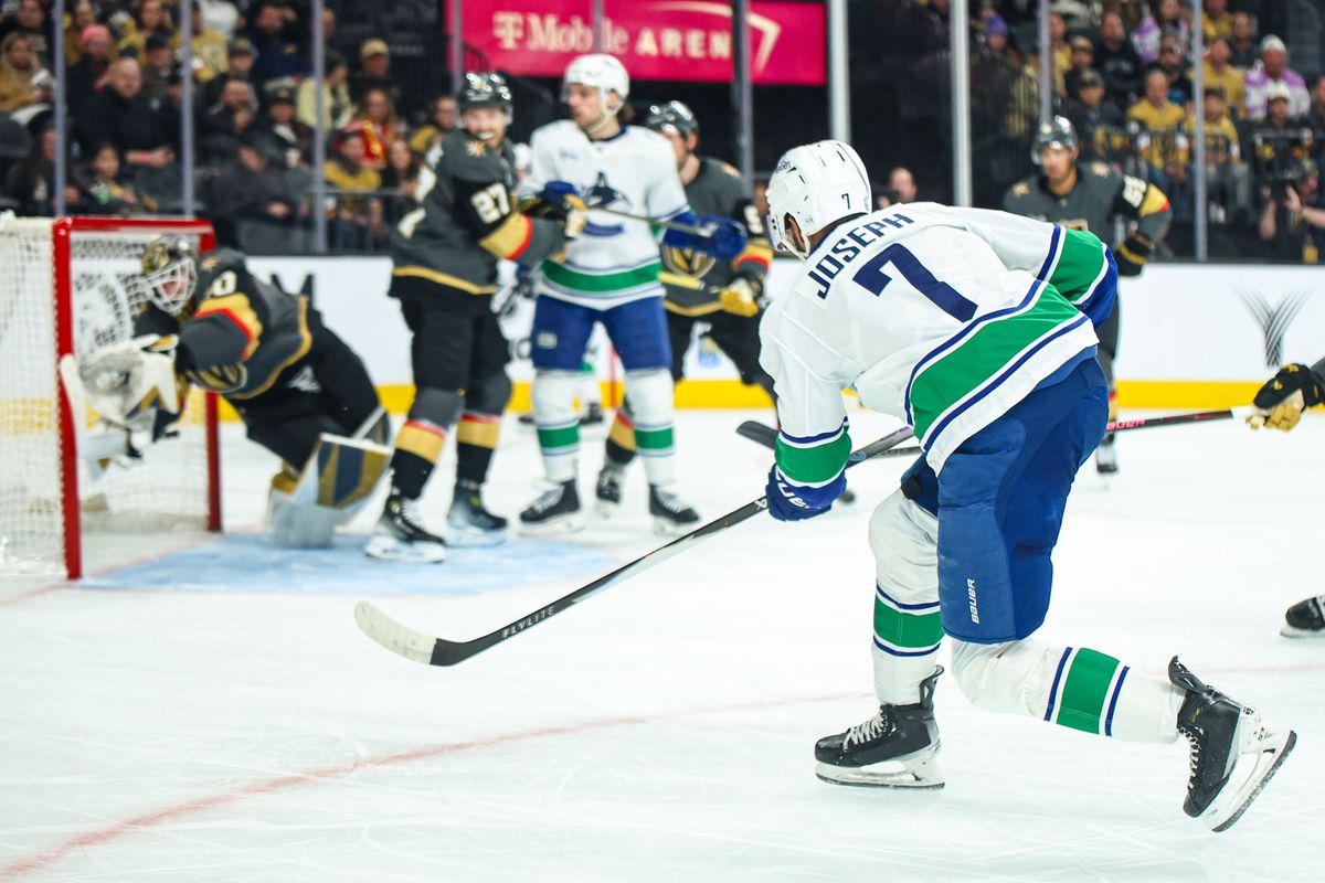 Vegas Golden Knights G Akira Schmid (40) makes a diving save against Vancouver Canucks D Pierre-Olivier Joseph (7) on Wednesday February 4, 2026, in Las Vegas, Nevada. 