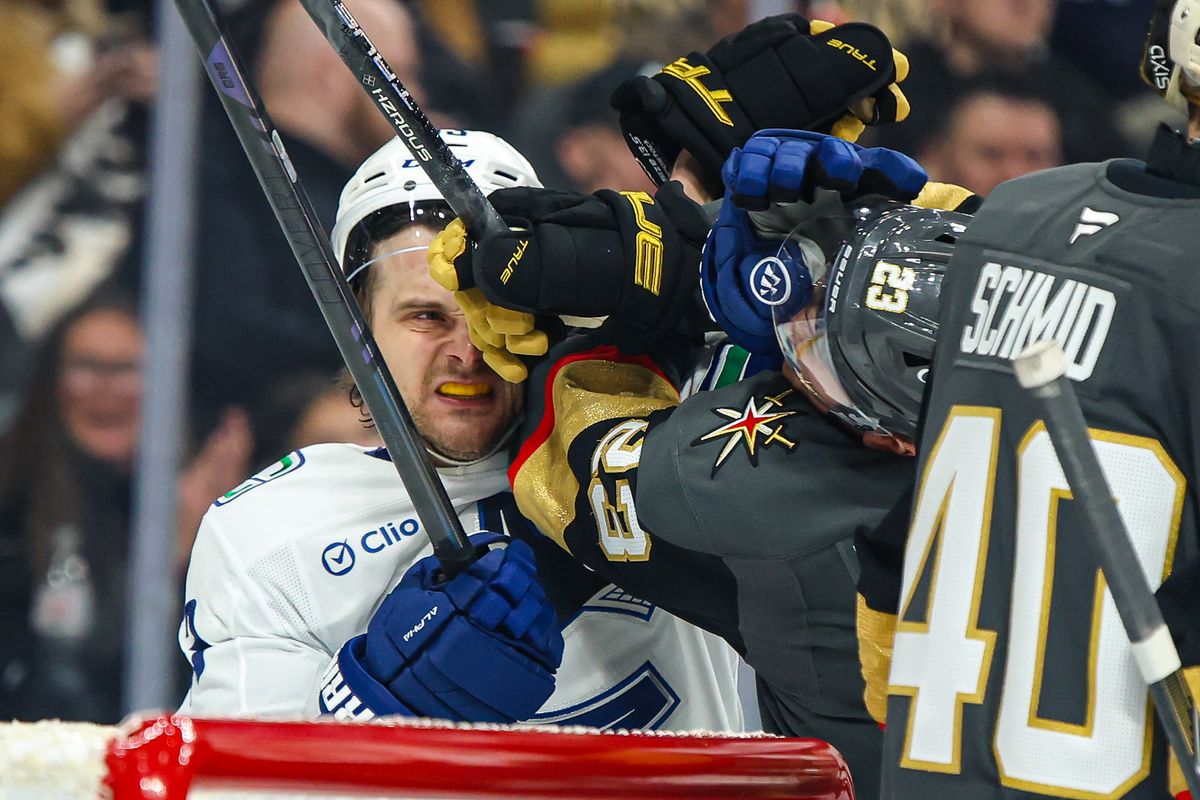 Vancouver Canucks F Teddy Blueger (53) and Vegas Golden Knights F Cole Reinhardt (23) get into a scrum during an NHL game on Wednesday February 4, 2026, in Las Vegas, Nevada. 