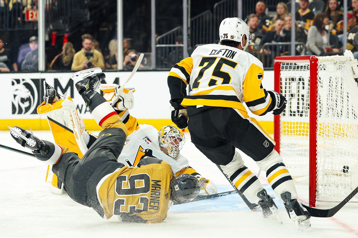 Vegas Golden Knights F Mitch Marner (93) scores a goal while falling over Pittsburgh Penguins G Arturs Silovs (37) during the second period of an NHL game on Thursday, March 12, 2026, in Las Vegas, Nevada. 