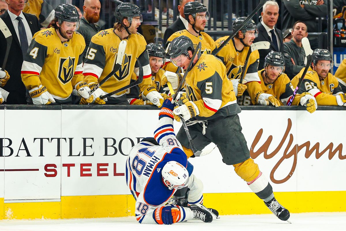 Vegas Golden Knights D Jeremy Lauzon (5) lays a hit on Edmonton Oilers F Zach Hyman (18) during an NHL game on Thursday, March 26, 2026, in Las Vegas, Nevada. Vegas Golden Knights D Jeremy Lauzon (5) lays a hit on Edmonton Oilers F Zach Hyman (18) during an NHL game on Thursday, March 26, 2026, in Las Vegas, Nevada.