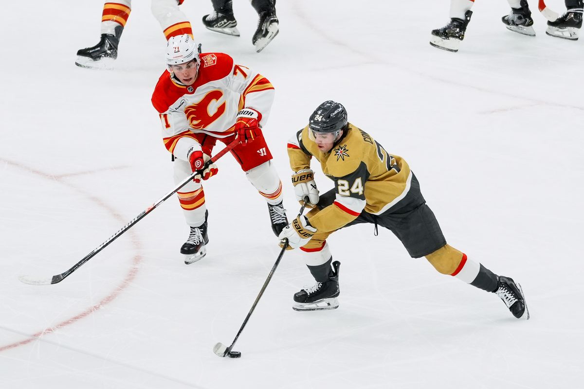 Vegas Golden Knights left wind Trevor Connelly (24) skates the puck down the ice followed by Calgary Flames defenseman Simon Nemec (71) during second period of NHL game against Calgary Flames on Thursday October 15, 2026 at T-Mobile Arena in Las Vegas. Vegas Golden Knights left wind Trevor Connelly (24) skates the puck down the ice followed by Calgary Flames defenseman Simon Nemec (71) during second period of NHL game against Calgary Flames on Thursday October 15, 2026 at T-Mobile Arena in Las Vegas.