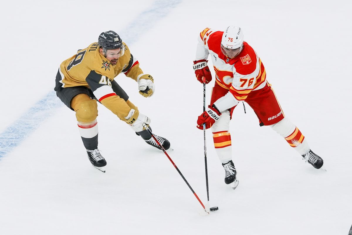 Vegas Golden Knights center Tomas Hertl (48) and Calgary Flames Martin Pospisil (76) reach for the puck during second period of NHL game against Calgary Flames on Thursday October 15, 2026 at T-Mobile Arena in Las Vegas. Vegas Golden Knights center Tomas Hertl (48) and Calgary Flames Martin Pospisil (76) reach for the puck during second period of NHL game against Calgary Flames on Thursday October 15, 2026 at T-Mobile Arena in Las Vegas.