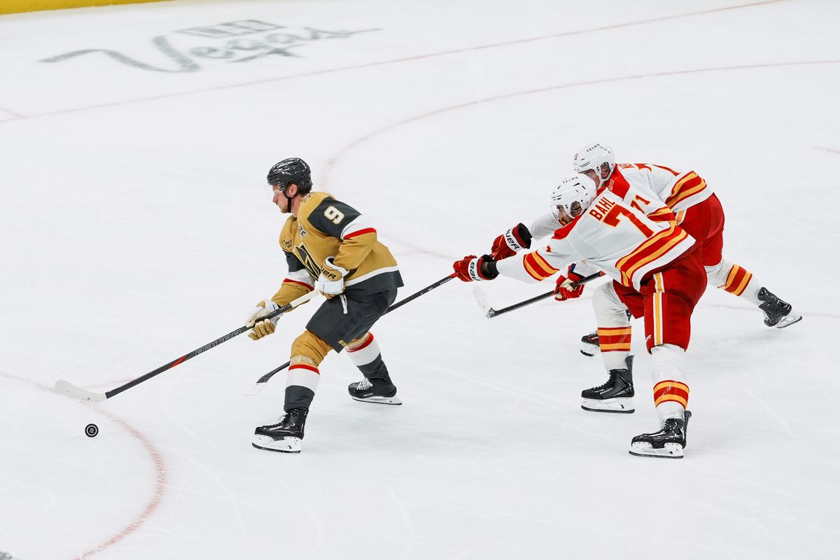 Vegas Golden Knights center Jack Eichel (9) skates the puck down ice, escaping Calgary Flames defenseman Simon Nemec (71) and Kevin Bahl (7) during third period of NHL game against Calgary Flames on Thursday October 15, 2026 at T-Mobile Arena in Las Vegas. Vegas Golden Knights center Jack Eichel (9) skates the puck down ice, escaping Calgary Flames defenseman Simon Nemec (71) and Kevin Bahl (7) during third period of NHL game against Calgary Flames on Thursday October 15, 2026 at T-Mobile Arena in Las Vegas.