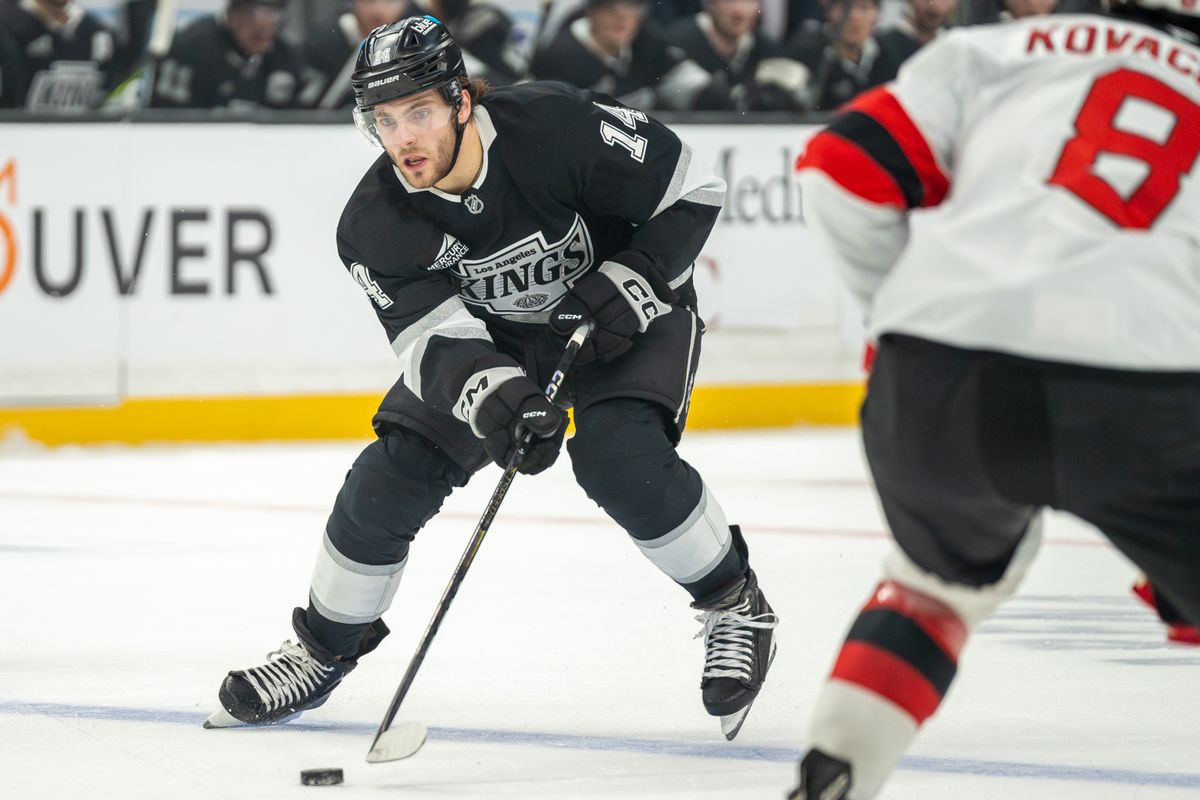 Alex Laferriere #14 of the Los Angeles Kings carries the puck up the ice during the first period against the New Jersey Devils at Crypto.com Arena on January 1, 2025, in Los Angeles, California.