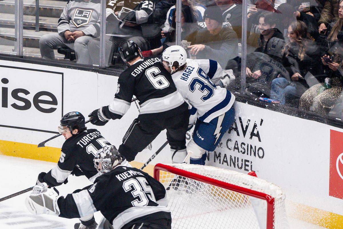 Los Angeles Kings D (6) Joel Edmundson slams his opponent into the glass in a game against the Tampa Bay Lightning on January 4, 2025 at Crypto.com Arena