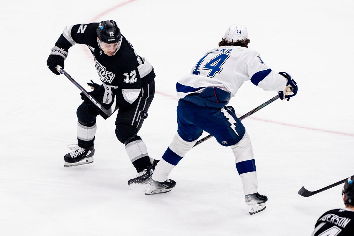 Los Angeles Kings LW (12) Trevor Moore and his opponent both trying to get the puck in a game against the Tampa Bay Lightning on January 4, 2025 at Crypto.com Arena