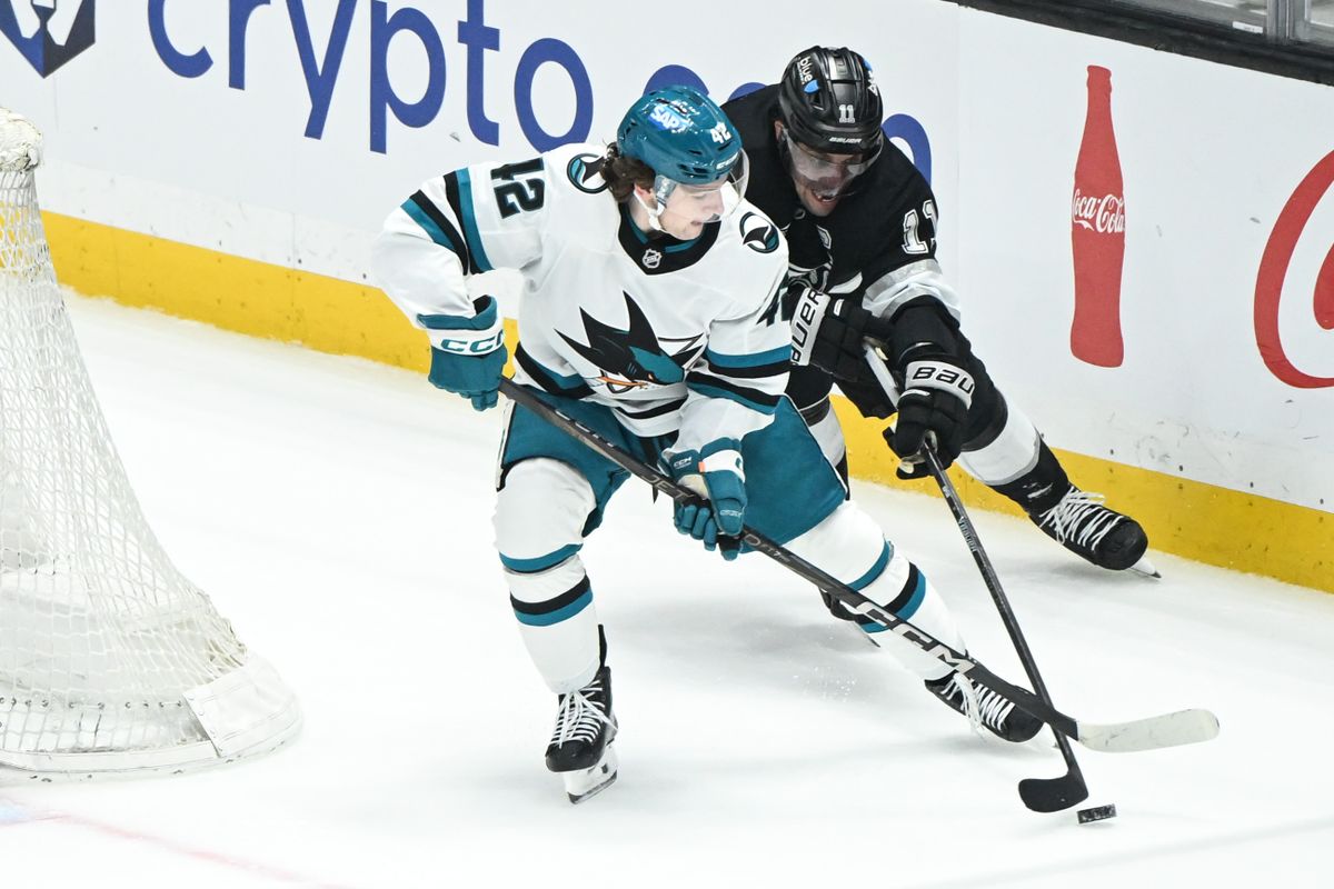 Los Angeles Kings Center Anze Kopitar (11) strips the puck from San Jose Sharks Defenseman Luca Cagnoni (42) during an NHL hockey game against, Sunday, March 30, 2025, in Los Angeles Calif.