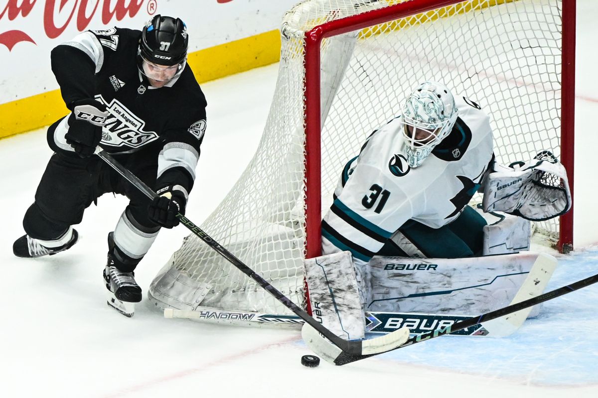 San Jose Sharks Goalie Georgi Romanov (31) makes a save on Los Angeles Kings Left Winger Trevor Moore's (12) shot during an NHL hockey game, Sunday, March 30, 2025, in Los Angeles Calif.