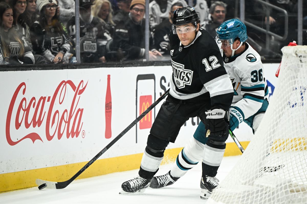 Los Angeles Kings Left Winger Trevor Moore (12) wins a puck battle against San Jose Sharks Defenseman Lucas Carlsson (36) during an NHL hockey game against the San Jose Sharks, Sunday, March 30, 2025, in Los Angeles Calif.