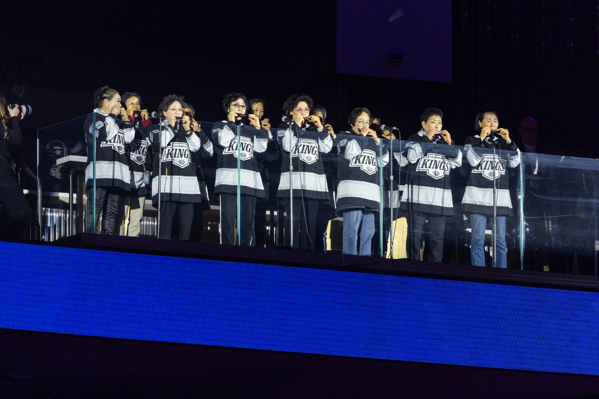 Harmonica players from the Koreatown Senior and Community Center perform the national anthem prior to Game 5 of the NHL Stanley Cup Playoffs against the Edmonton Oilers, Tuesday April 29, 2025 in Los Angeles, Calif.