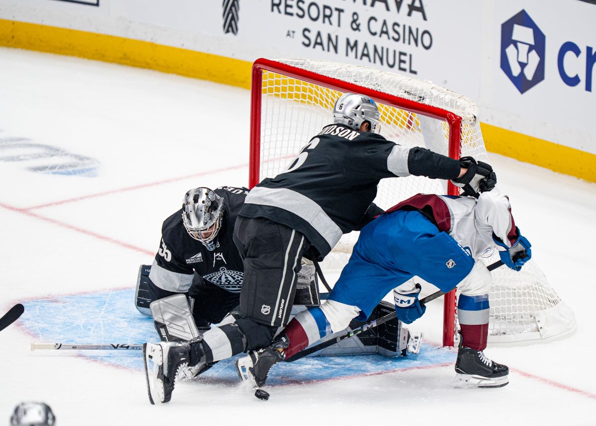 Los Angeles Kings defenseman, Joel Edmundson 6, shoves an Avalanche player while blocking at the net during an NHL hockey game against the Colorado Avalanche at Crypto.com Arena in Los Angeles on October 07, 2025
