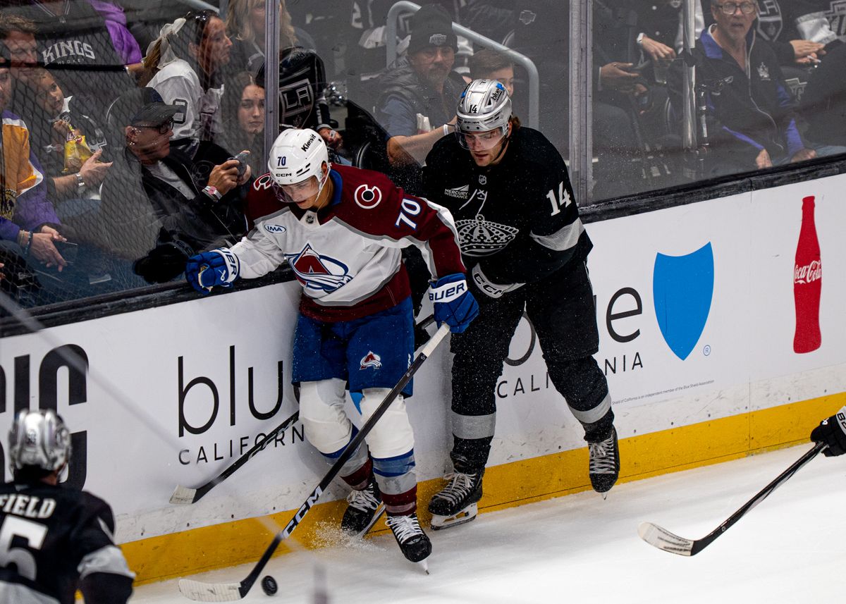 Los Angeles Kings right wing, Alex Laferriere 14, fights for the puck with Avalanche Sam Malinski 70 during an NHL hockey game against the Colorado Avalanche at Crypto.com Arena in Los Angeles on October 07, 2025
