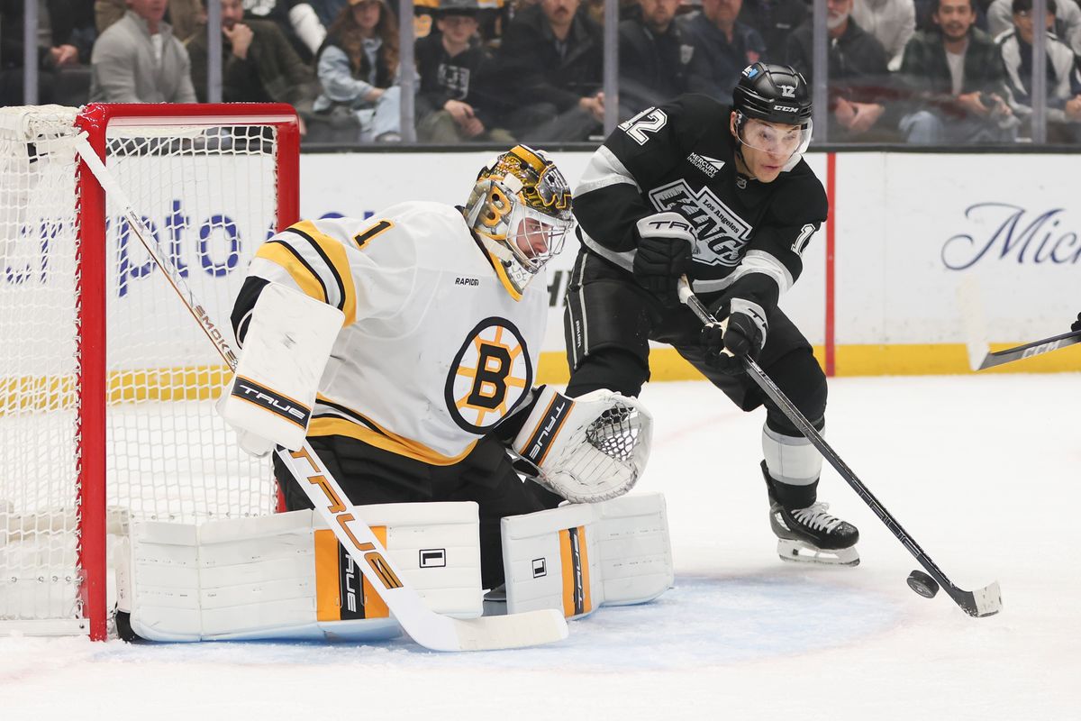 Left wing Trevor Moore #12 of the Los Angeles Kings attempts to get the puck on goal against goaltender Jeremy Swagman #1 of the Boston Bruins during an NHL hockey game, Friday November 21, 2025 in Los Angeles, Calif.