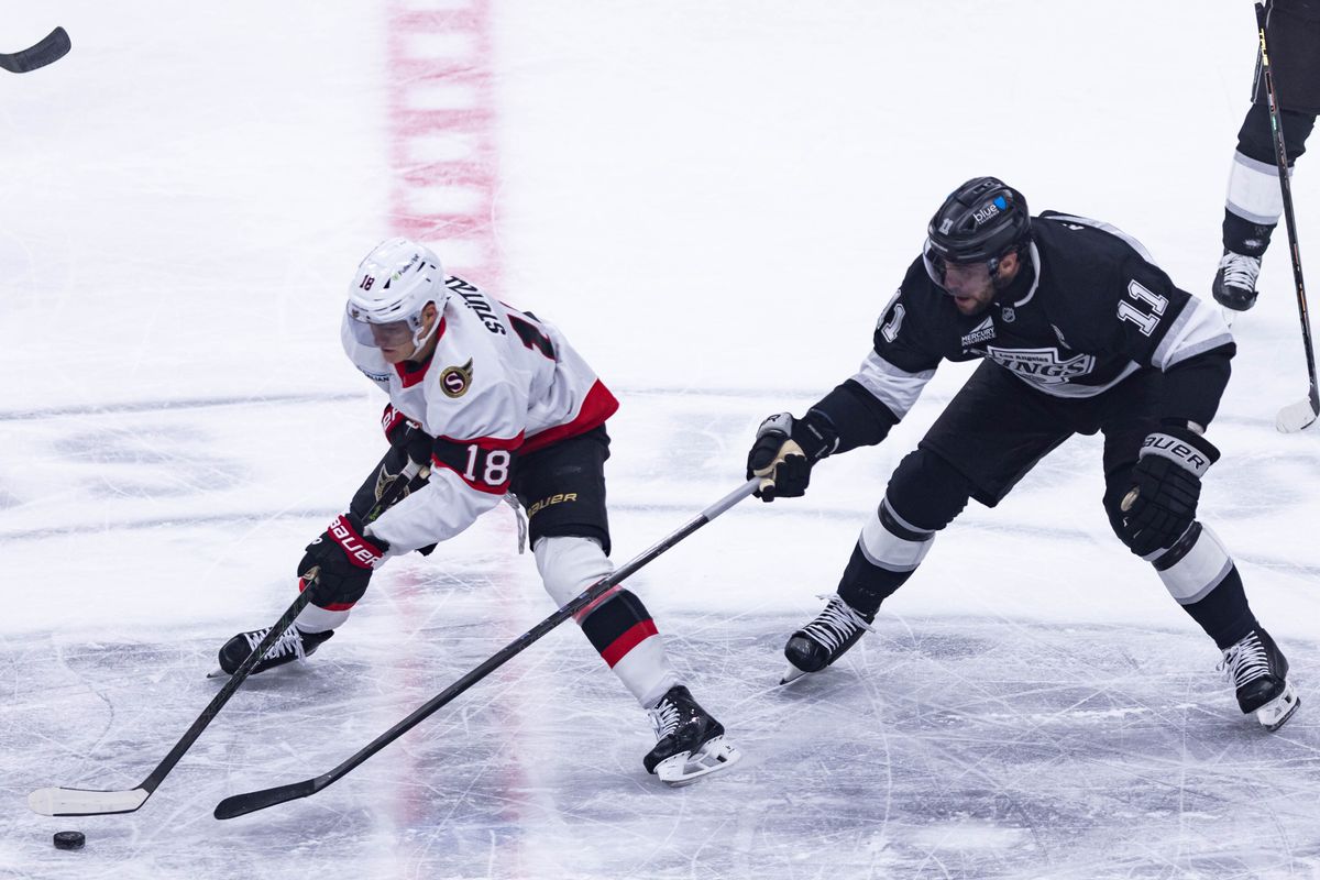 Los Angeles Kings center Anze Kopitar (11) attempts to get the puck from Ottawa Senators center Tim Stutzle (18) during an NHL matchup with the Los Angeles Kings against the Ottawa Senators on November 24, 2025 in Los Angeles, Calif.