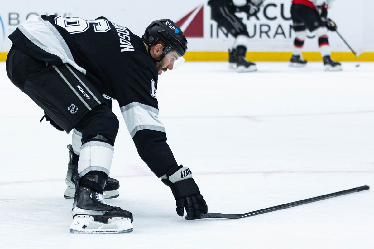 Los Angeles Kings defense Joel Edmunson (6) retrieves his stick during an NHL game against the Ottawa Senators on November 24, 2025 in Los Angeles, Calif.