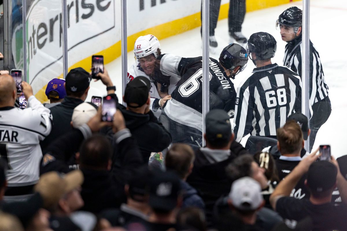 Defenseman Joel Edmundson #6 of the Los Angeles Kings and right wing Brandon Duhaime #22 of the Washington Capitals fight during an NHL hockey game, Tuesday December 2, 2025 in Los Angeles, Calif.