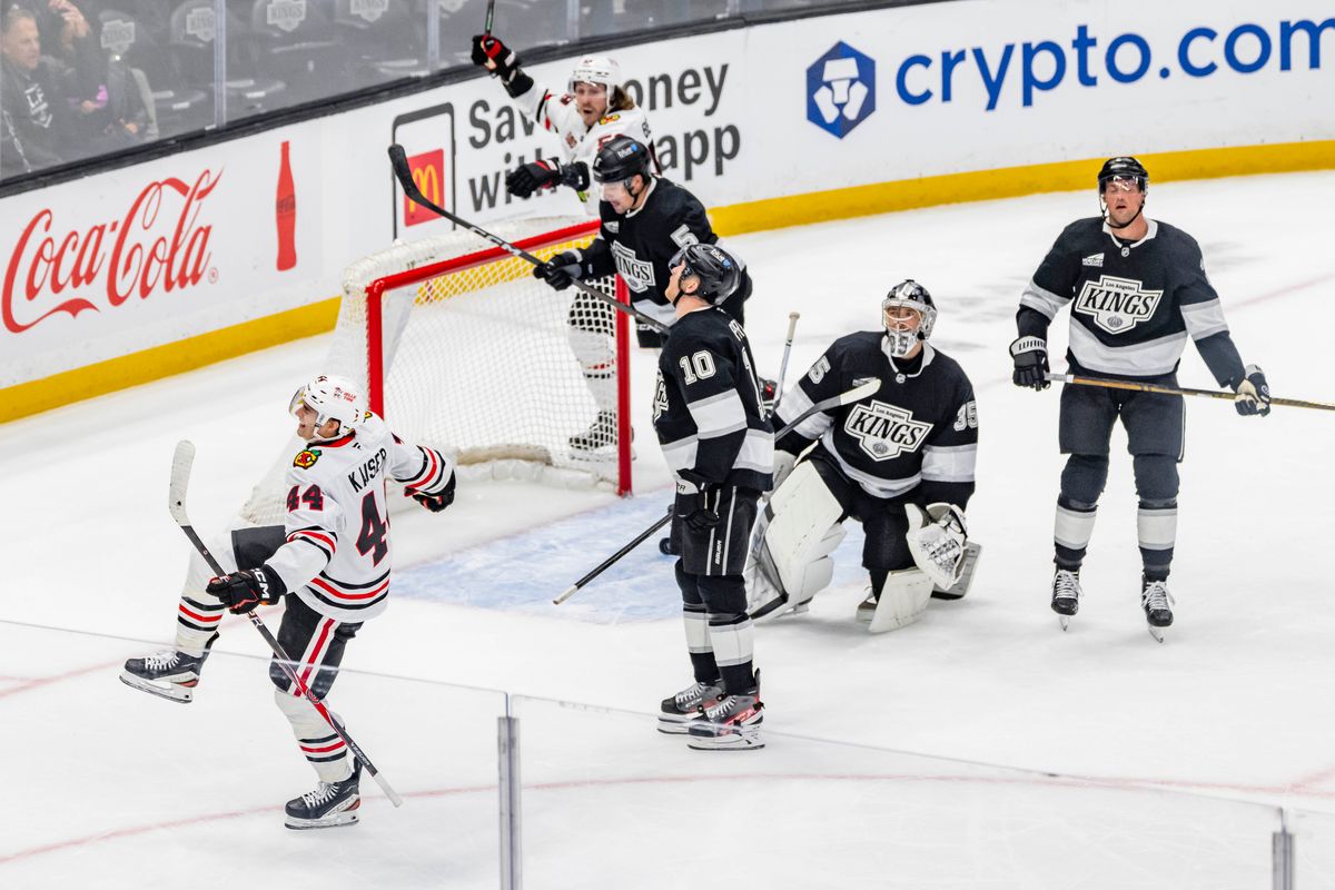 Defenseman Wyatt Kaiser #44 of the Chicago Blackhawks celebrates a goal as the dejected Los Angeles Kings look on during an NHL hockey game, Thursday December 4, 2025 in Los Angeles, Calif.