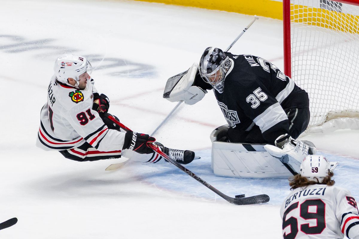 Center Frank Nazar #91 of the Chicago Blackhawks shoots the puck as he slides towards goaltender Darcy Kuemper #35 of the Los Angeles Kings during an NHL hockey game, Thursday December 4, 2025 in Los Angeles, Calif.
