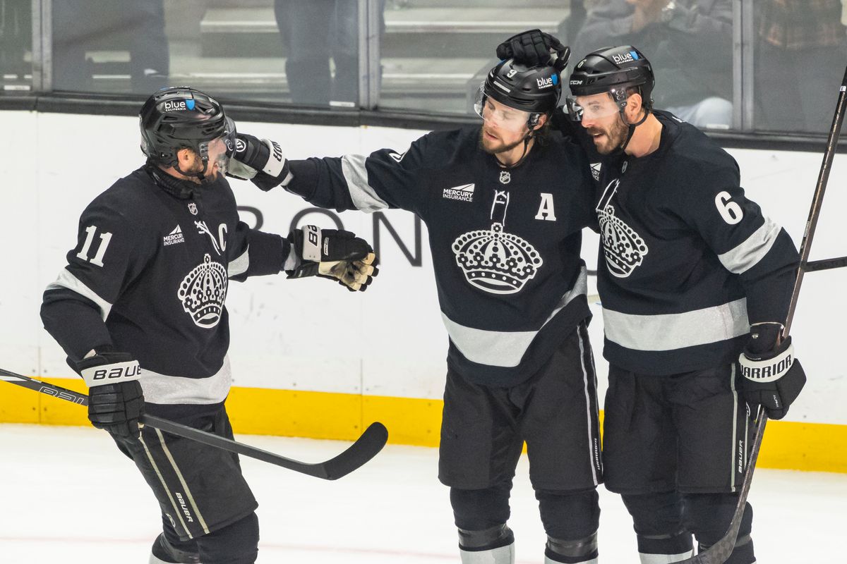 Center Anze Kopitar #11, right wing Adrian Kempe #9, and defenseman Joel Edmundson #6 of the Los Angeles Kings celebrate a goal during an NHL hockey game against the Calgary Flames, Saturday December 13, 2025 in Los Angeles, Calif.