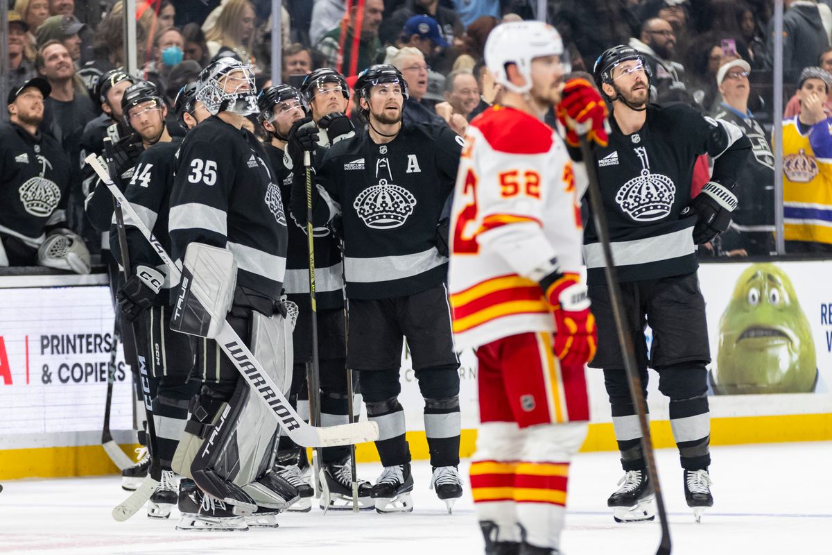 The Los Angeles Kings look up at the scoreboard during a replay review in overtime that ultimately overturned their game-winning goal during an NHL hockey game against the Calgary Flames, Saturday December 13, 2025 in Los Angeles, Calif.