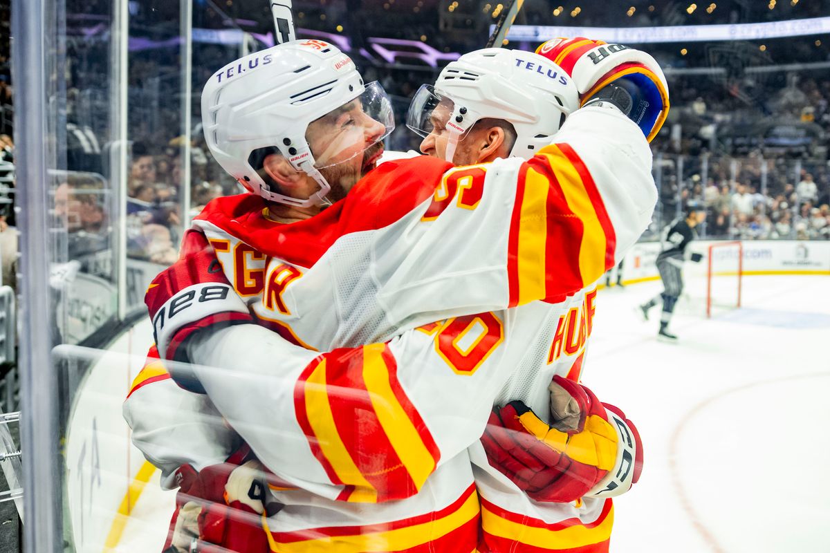 Defenseman Mackenzie Weegar #52 of the Calgary Flames and left wing Jonathan Huberdeau #10 of the Calgary Flames celebrate the victory in overtime during an NHL hockey game against the Los Angeles Kings, Saturday December 13, 2025 in Los Angeles, Calif. 