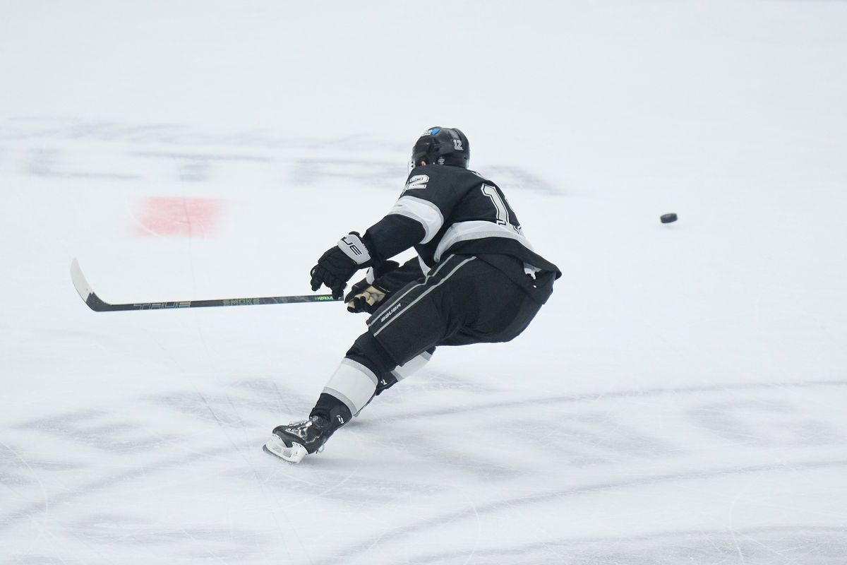 Los Angeles Kings left wing Trevor Moore (12) cuts for the puck against the Kraken at the crypto.com Arena on December 23,2025 in Los Angeles, California.
