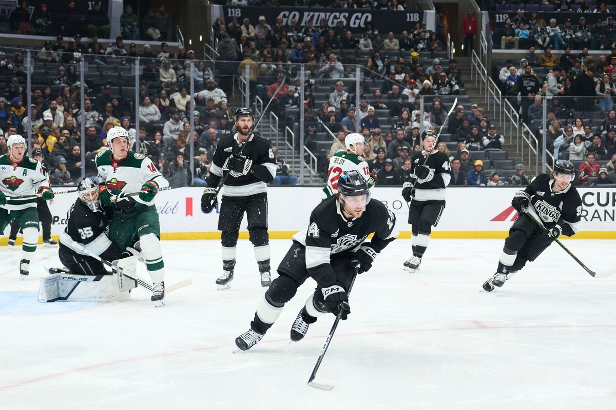 The Los Angeles Kings right wing  Alex Laferriere (14) clears the puck against the Minnesota Wild at the Crypto Arena on January 5th, 2026 in Los Angeles California.