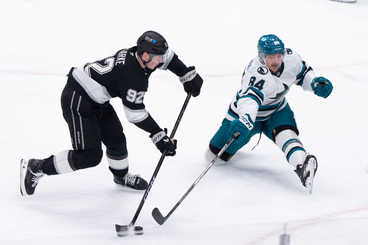 The Los Angeles Kings Defender Brandt Clarke (92) takes a slap shot while the defender tries to steal the puck in a NHL game against the San Jose Sharks at the Crypto Arena on January 7th, 2026 in Los Angeles California.