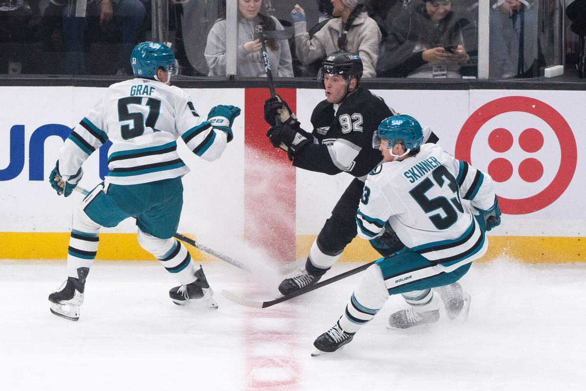 The Los Angeles Kings Defender Brandt Clarke  (92) gets trapped by two defenders on the wall in a NHL game against the San Jose Sharks at the Crypto Arena on January 7th, 2026 in Los Angeles California.