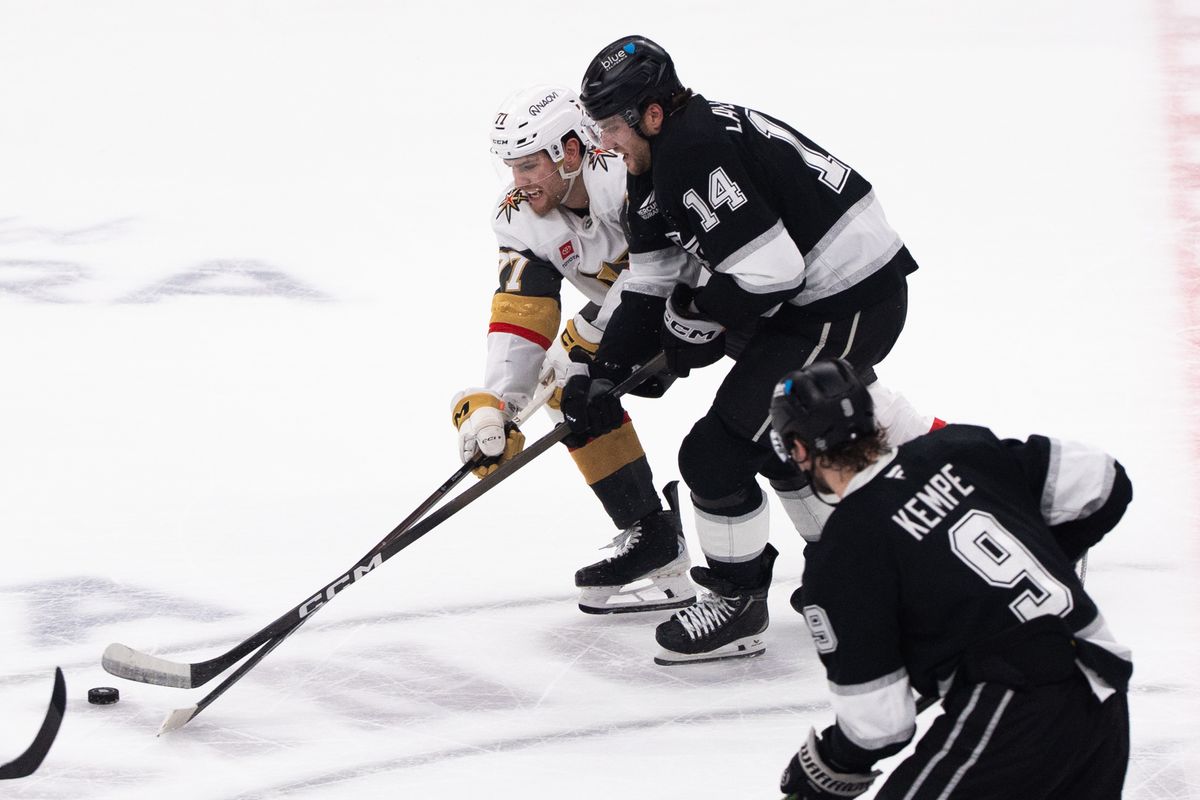 Los Angeles Kings Right Wing Alex Laferriere (14) fights off his opponent to try and steal the puck during an NHL match against the Vegas Golden Knights on February 25, 2025 in Los Angeles, Calif.