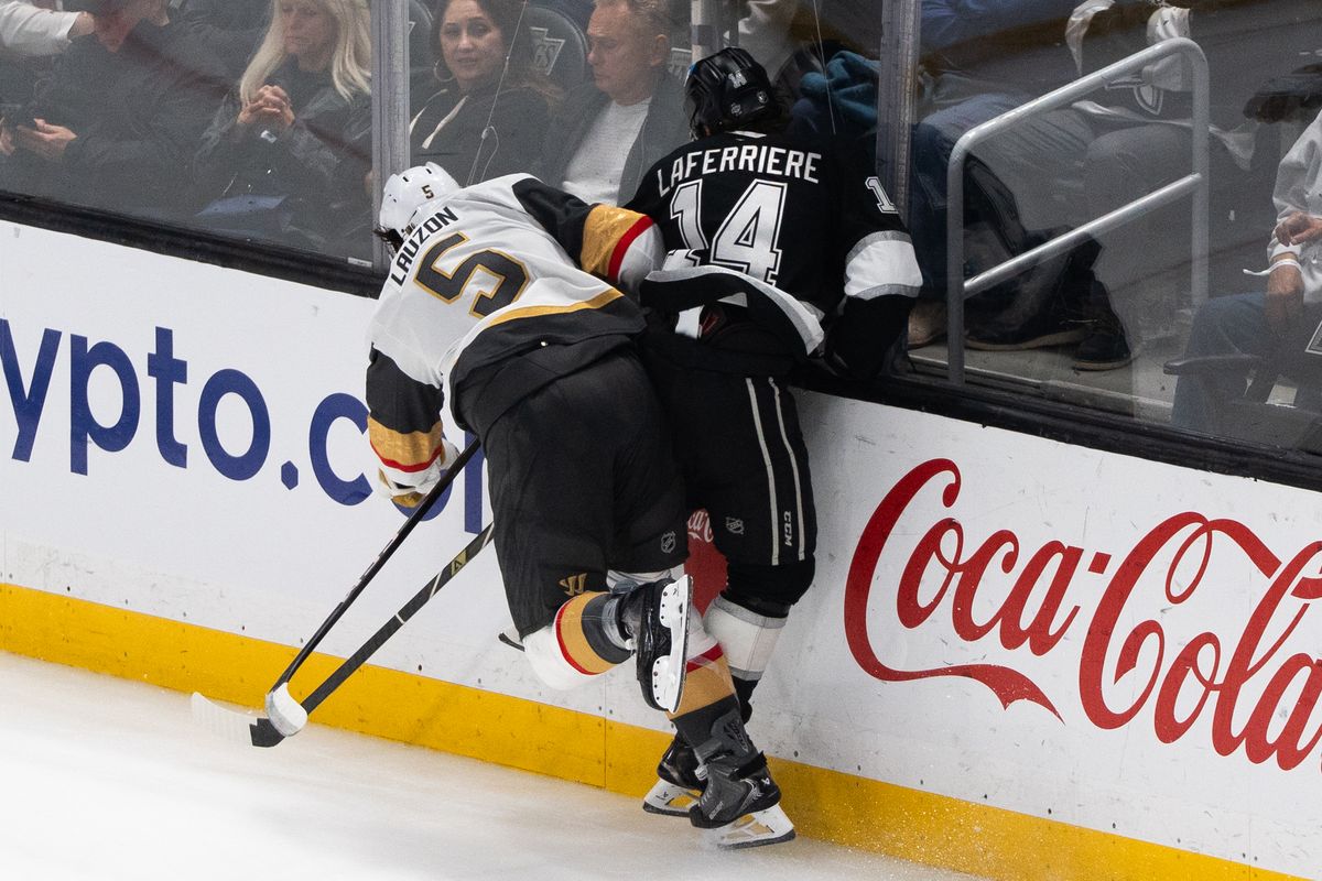 Los Angeles Kings Right Wing Alex Laferriere (14) gets slammed into the glass during an NHL match against the Vegas Golden Knights on February 25, 2025 in Los Angeles, Calif.