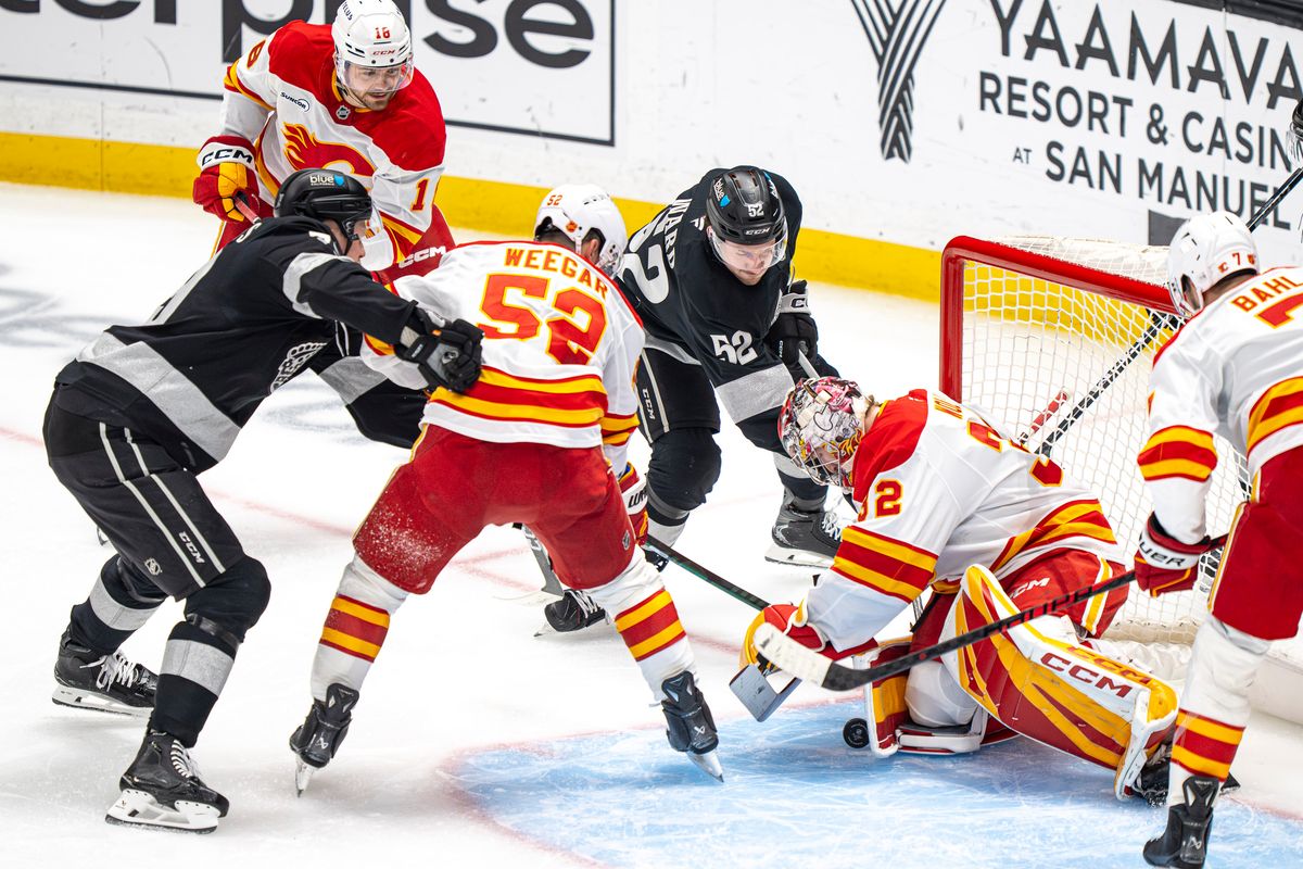 Calgary Flames goalie Dustin Wolf (32) successfully blocking a shot on goal during an NHL hockey game against the Los Angeles Kings on February 26th, 2026 in Los Angeles, CA.