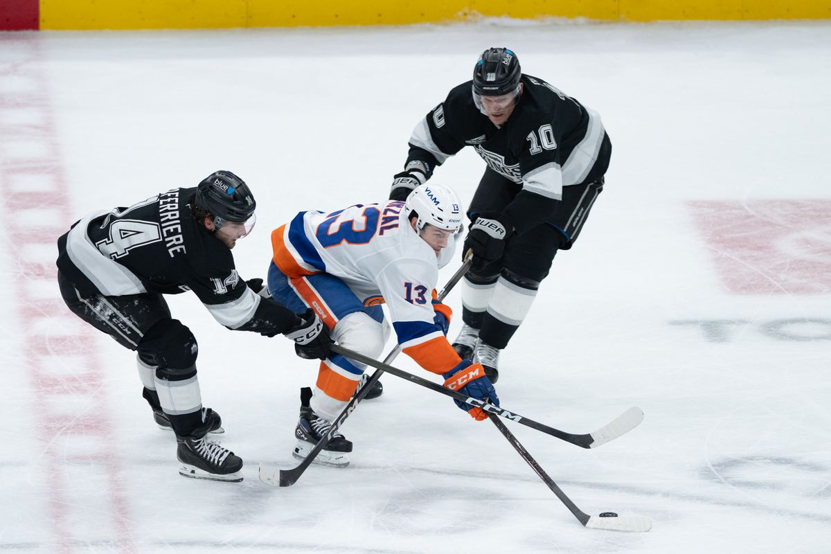 New York Islanders center Mathew Barzal (13) pushes the puck through two defenders during an NHL game between the New York Islanders and the Los Angeles Kings on Thursday, March 5, 2026 at Crypto.com Arena in Los Angeles Calif