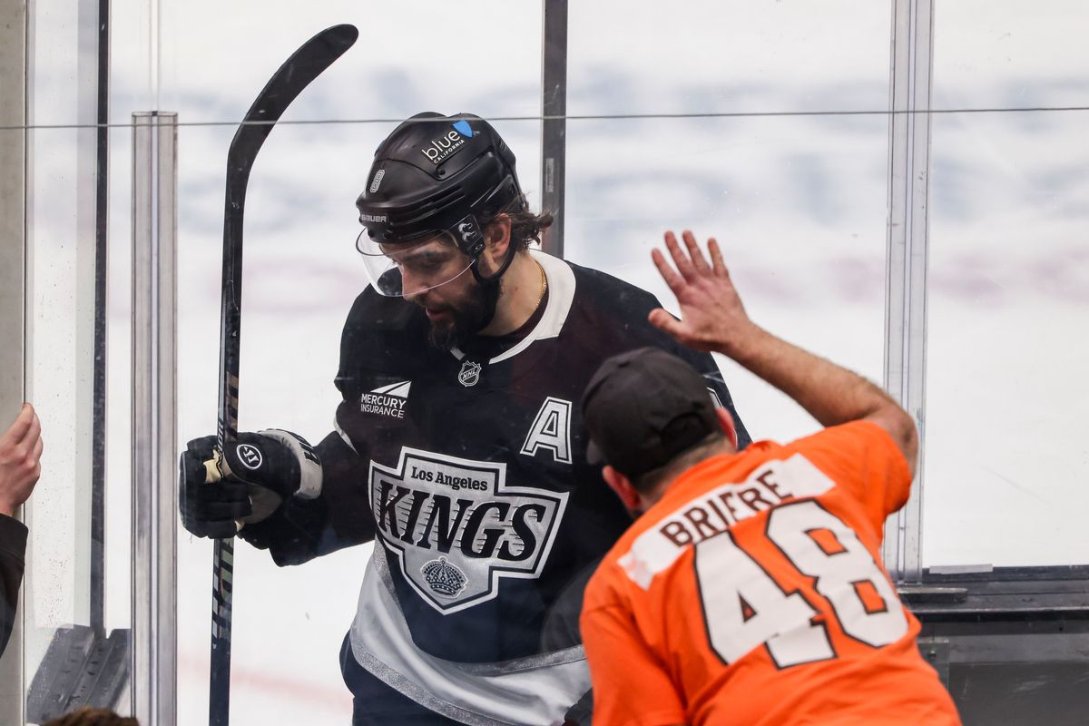 A Philadelphia Flyers fan interacts with Drew Doughty #8 of the Los Angeles Kings as he enters the penalty box during an NHL hockey game against the Philadelphia Flyers, Thursday March 19, 2026 in Los Angeles, Calif.