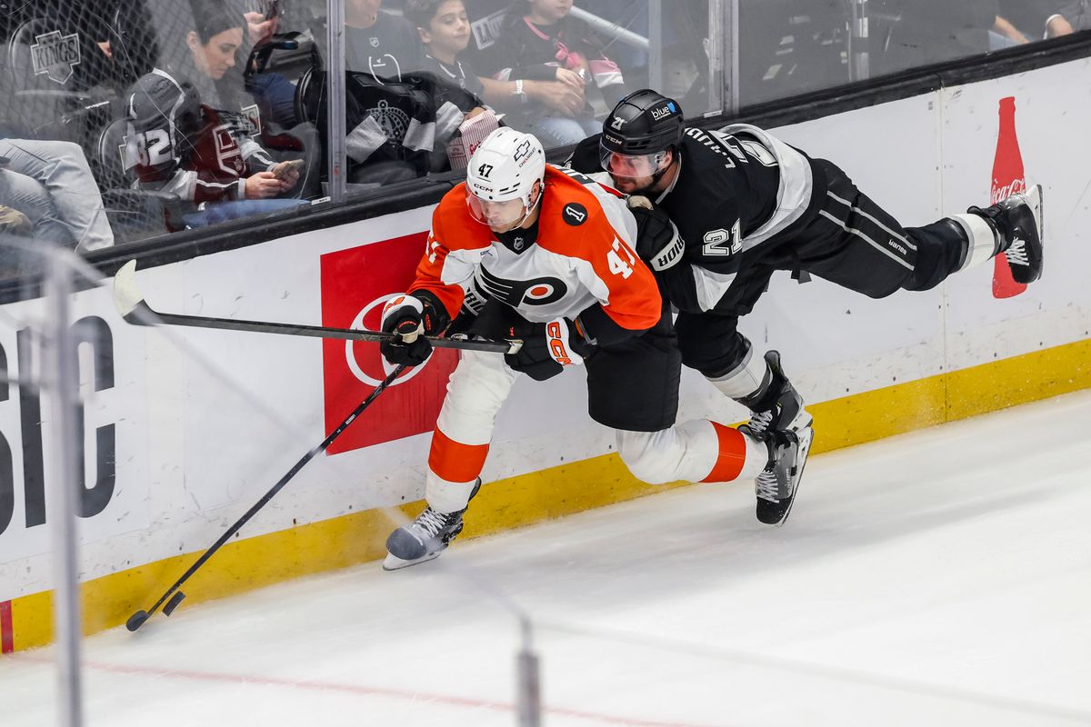 Scott Laughton #21 of the Los Angeles Kings reaches for the puck overNoah Juulsen #47 of the Philadelphia Flyers during an NHL hockey game, Thursday March 19, 2026 in Los Angeles, Calif.