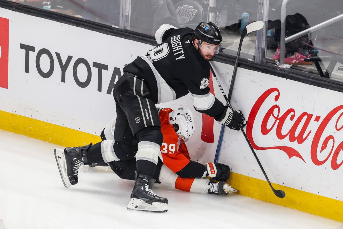 Drew Doughty #8 of the Los Angeles Kings checks Matvei Michkov #39 of the Philadelphia Flyers hard into the boards during an NHL hockey game, Thursday March 19, 2026 in Los Angeles, Calif.