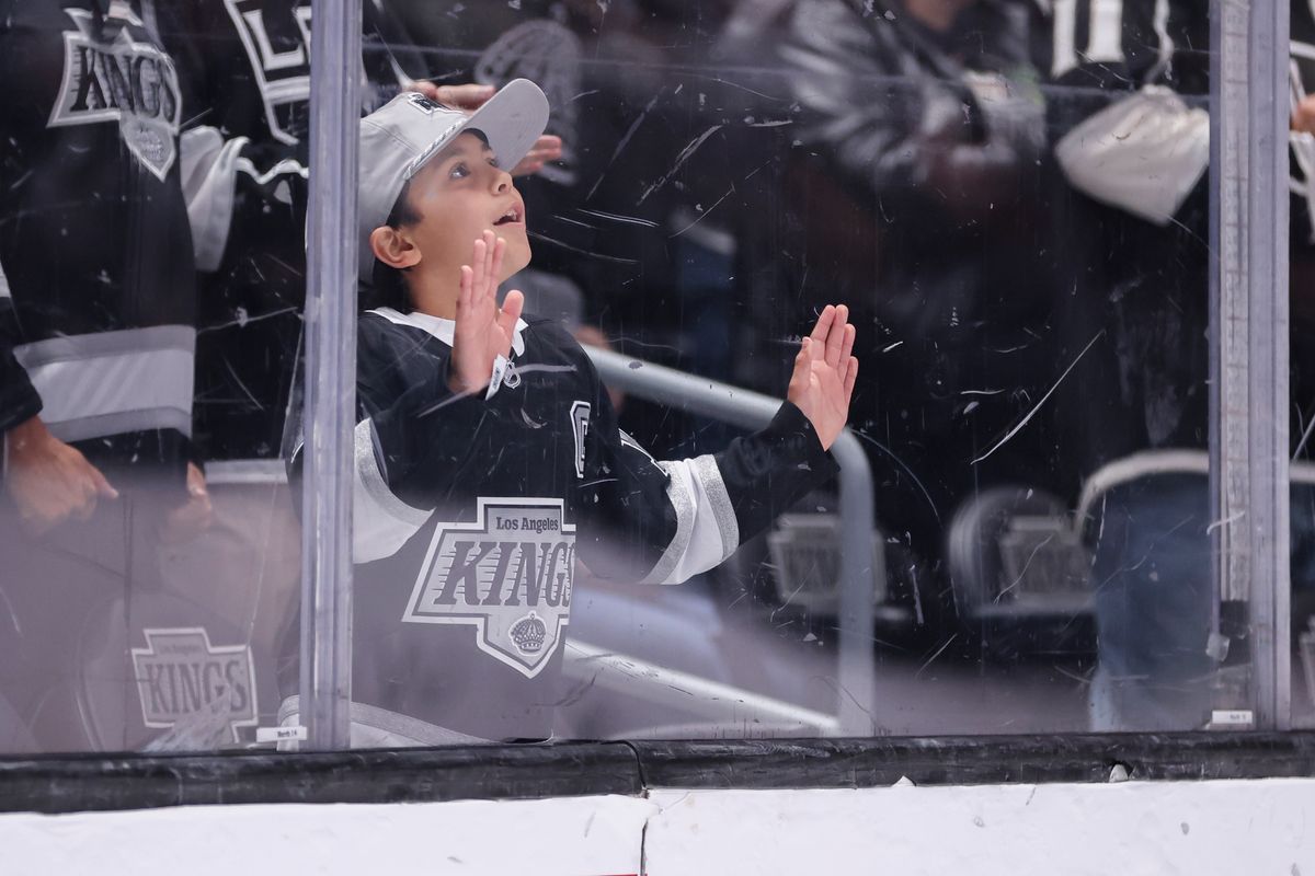 A young Los Angeles Kings fan looks on during an NHL hockey game against the Nashville Predators, Thursday April 2, 2026 in Los Angeles, Calif.
