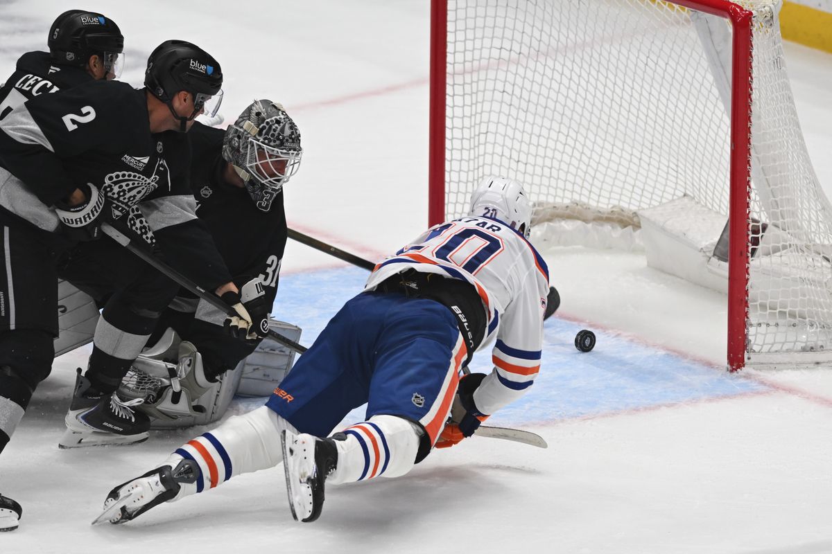 Edmonton Oilers center Curtis Lazar (20) attempts to push the puck to the net before getting blocked during an NHL game between the Edmonton Oilers and the Los Angeles Kings on Saturday, April 11, 2026 at Crypto.com Arena in Los Angeles Calif