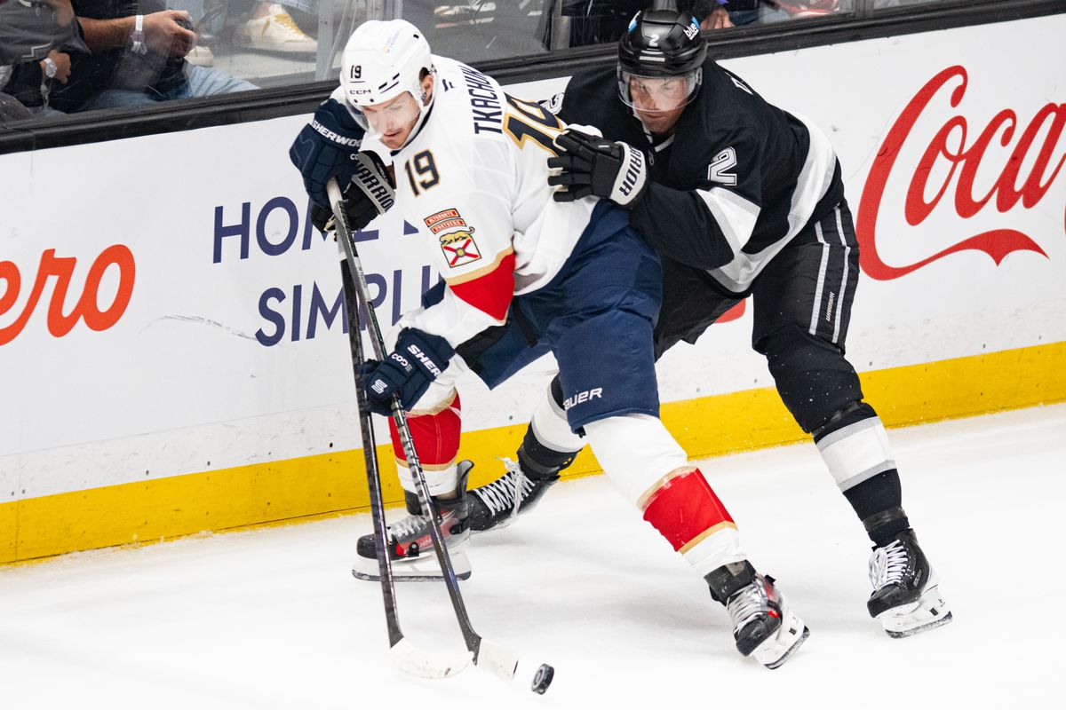 Los Angeles Kings defensiveman Brian Dumoulin (2) battles for the puck against Florida Panthers left wing Matthew Tkachuk (19) during an NHL hockey game against the Florida Panthers, Tuesday, October 6, 2026 in Los Angeles. Los Angeles Kings defensiveman Brian Dumoulin (2) battles for the puck against Florida Panthers left wing Matthew Tkachuk (19) during an NHL hockey game against the Florida Panthers, Tuesday, October 6, 2026 in Los Angeles.