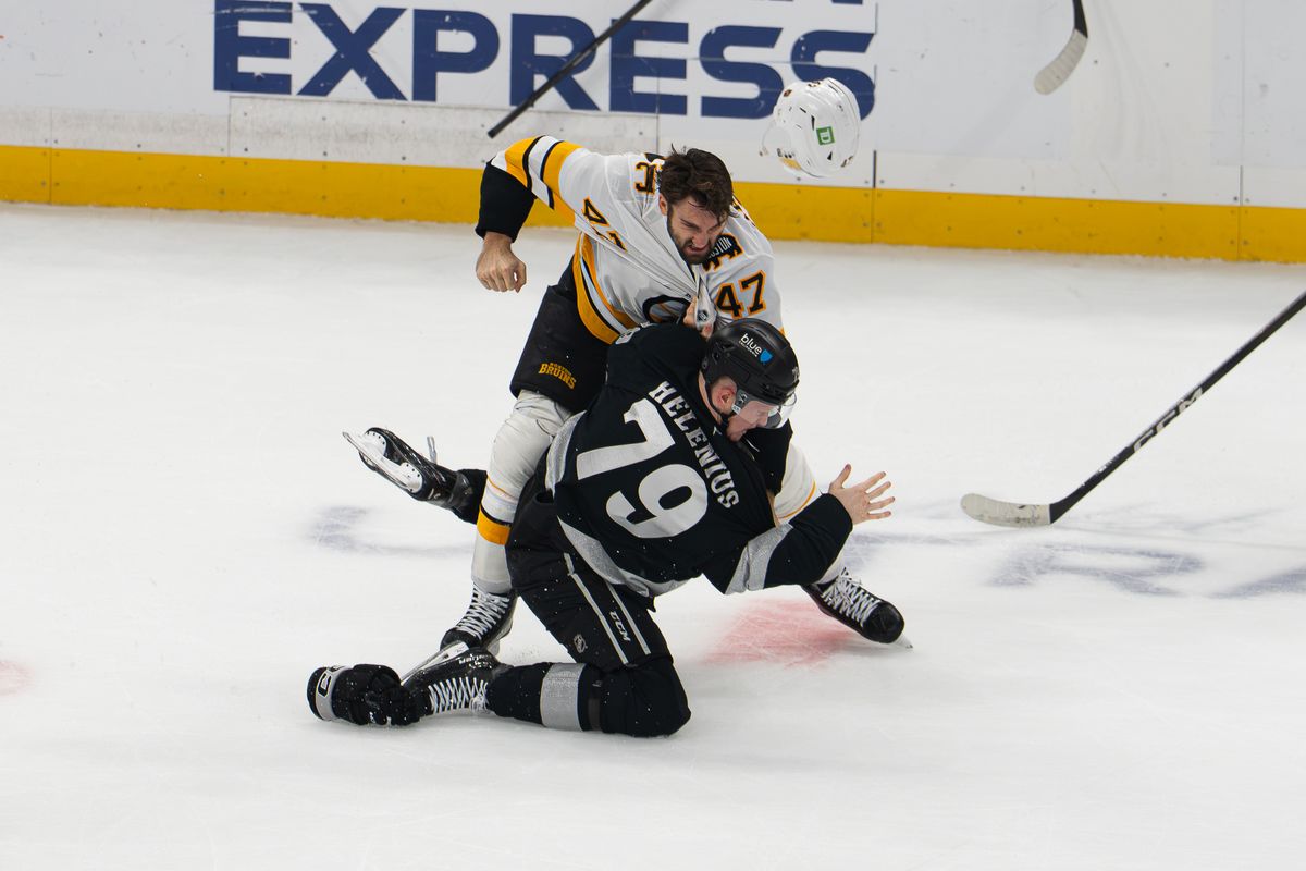 Boston Bruins center Mark Kastelic (47) fights with Los Angeles Kings center Samuel Helenius (79) during an NHL game, Saturday, Oct. 17, 2026, in Los Angeles, California. Boston Bruins center Mark Kastelic (47) fights with Los Angeles Kings center Samuel Helenius (79) during an NHL game, Saturday, Oct. 17, 2026, in Los Angeles, California.