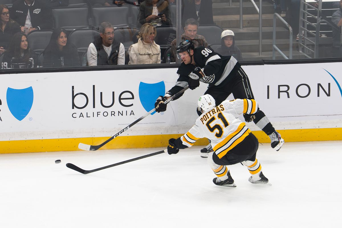 Los Angeles Kings right wing Corey Perry (90) passes around a Boston Bruins defender during an NHL game, Saturday, Oct. 17, 2026, at Crypto.com Arena in Los Angeles, California. Los Angeles Kings right wing Corey Perry (90) passes around a Boston Bruins defender during an NHL game, Saturday, Oct. 17, 2026, at Crypto.com Arena in Los Angeles, California.