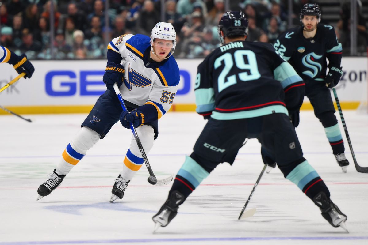 St. Louis Blues center Nikita Alexandrov (59) plays the puck while defended by Seattle Kraken defenseman Vince Dunn (29) during the third period at Climate Pledge Arena. St. Louis Blues center Nikita Alexandrov (59) plays the puck while defended by Seattle Kraken defenseman Vince Dunn (29) during the third period at Climate Pledge Arena.