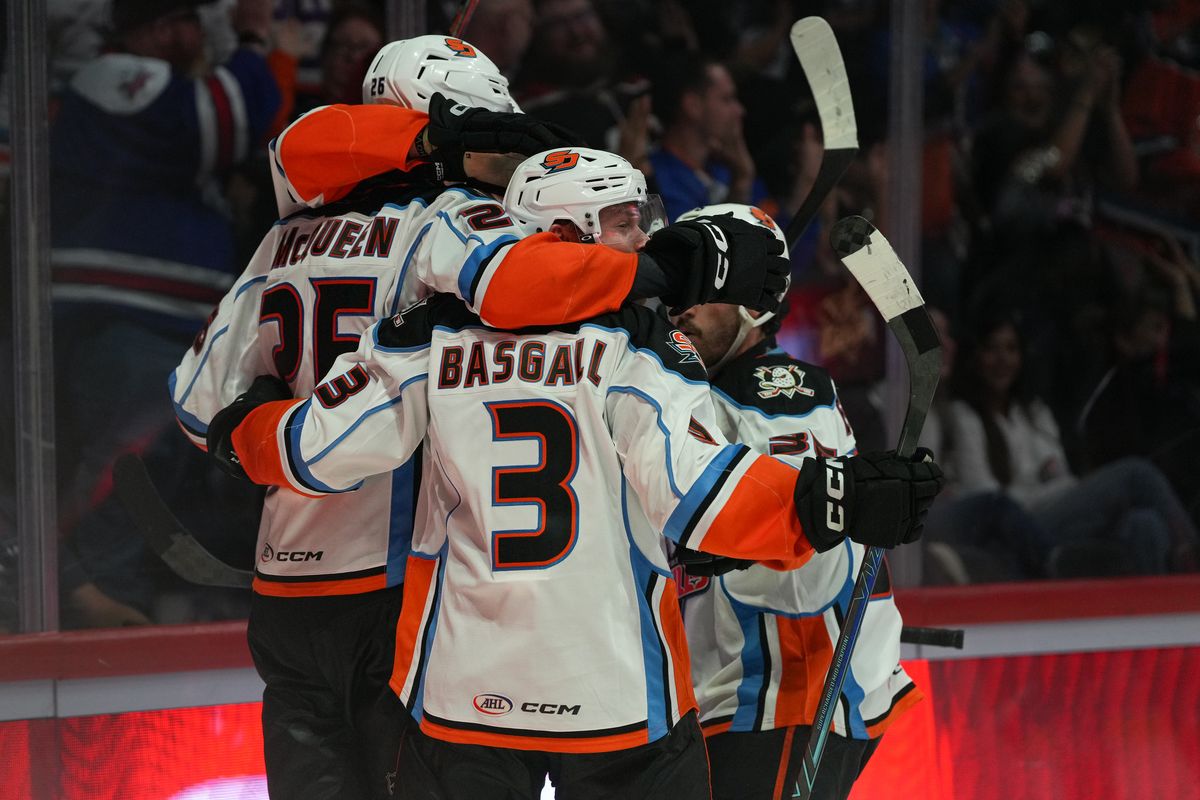 Gulls defenseman Matt Basgall (3) celebrates with teammates after the Gulls score a goal during an AHL hockey game against the Knights, Saturday October 10, 2026 in San Diego, California.